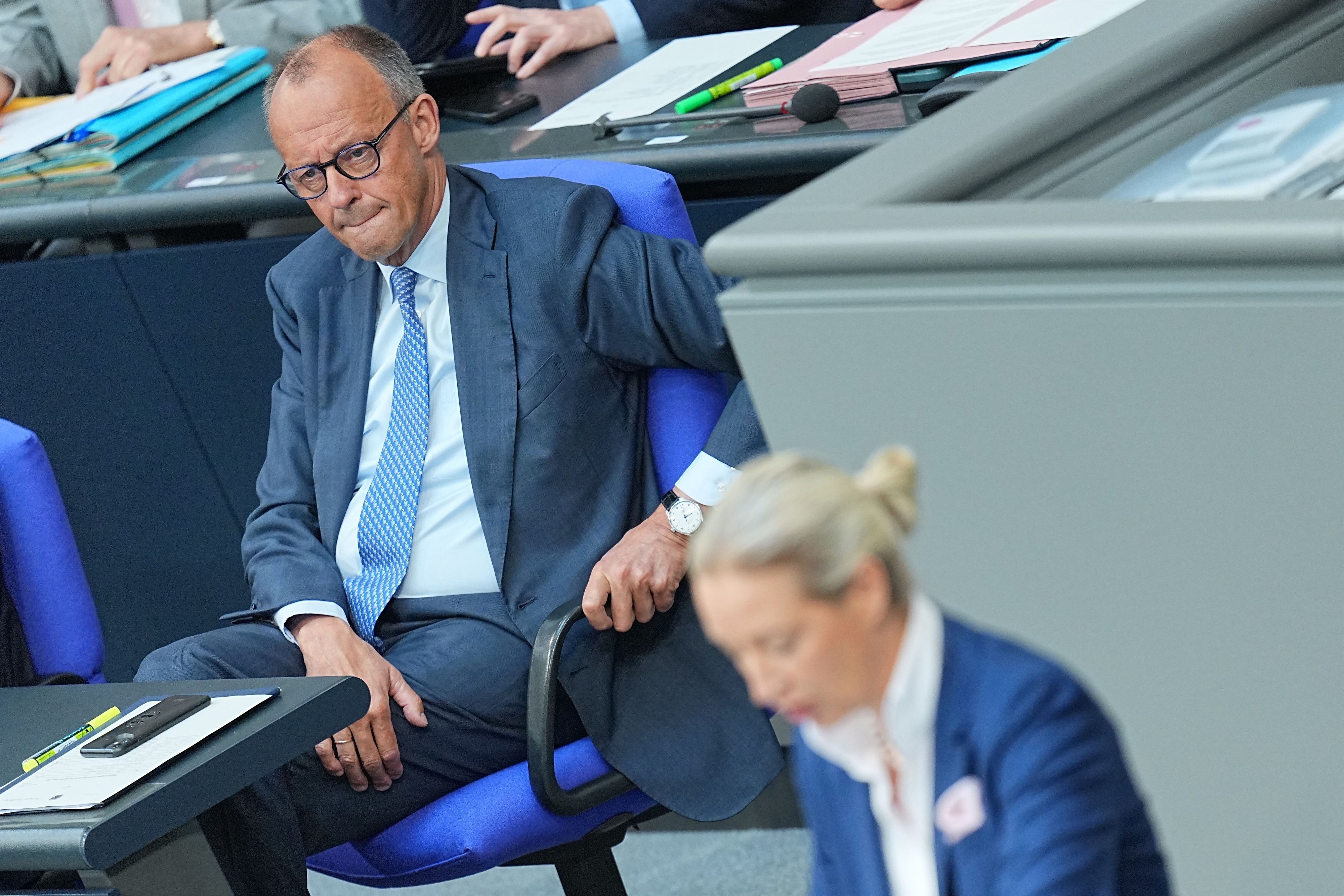 Bundeskanzler Friedrich Merz hört Alice Weidel aufmerksam zu.