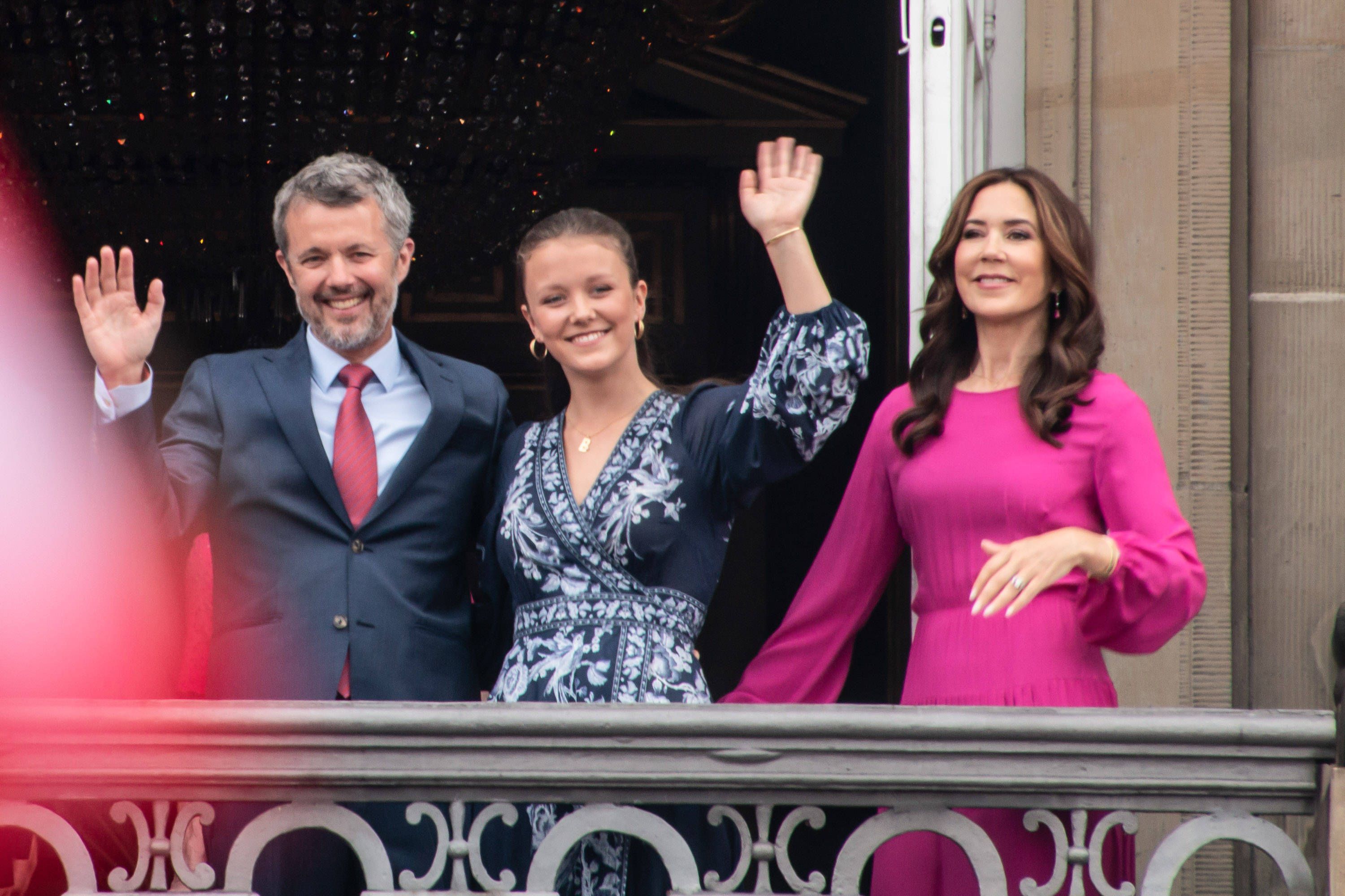Frederik, Isabella und Mary winken auf dem Balkon des Palastes.