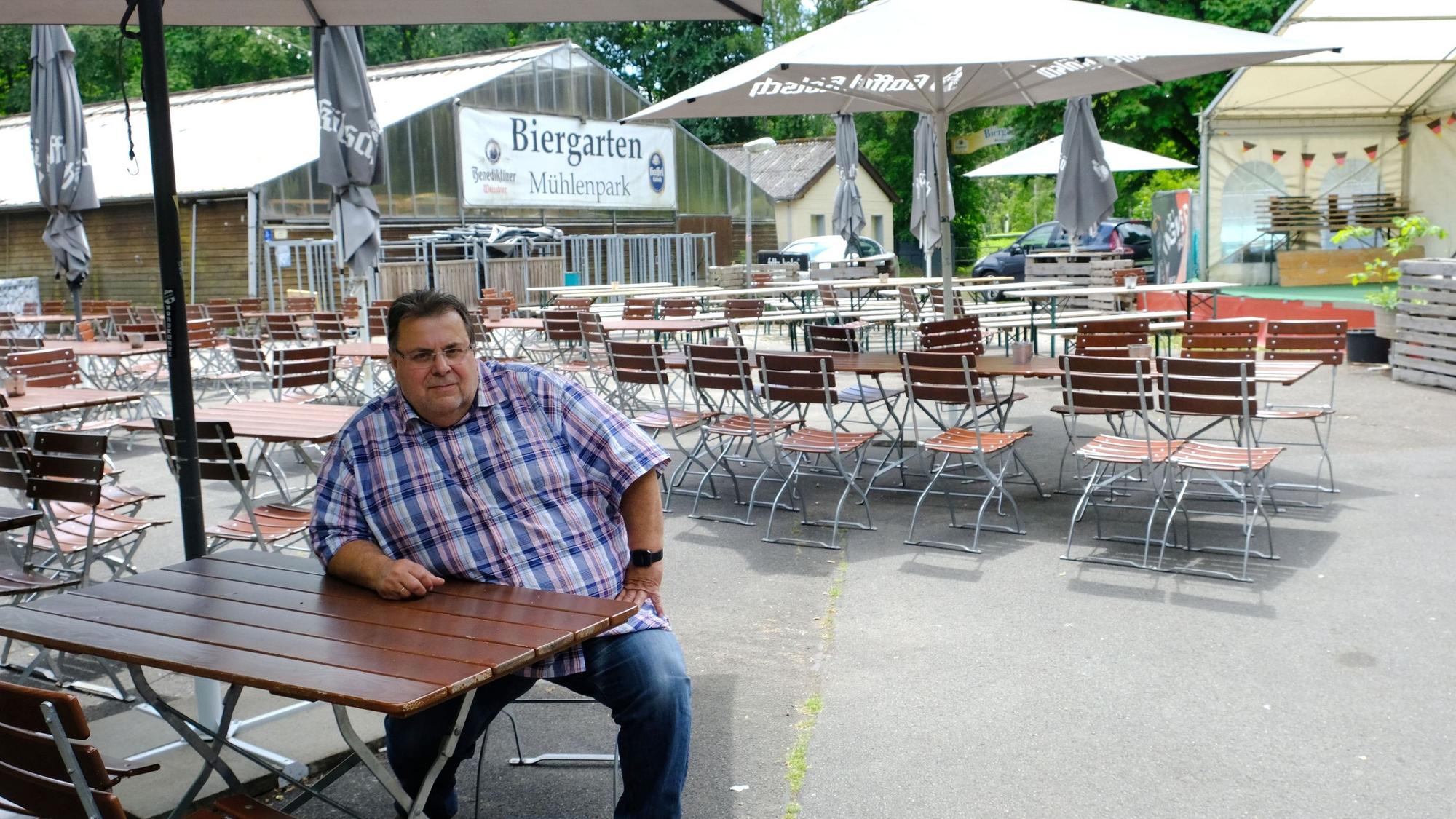 Helmut Wagner sitzt an einem Tisch seines Biergartens im Kommerner Mühlenpark.