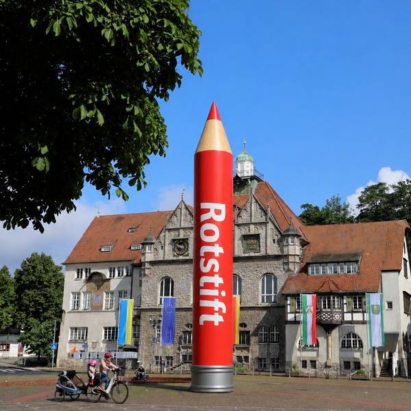 Das Bild zeigt einen großen Rotstift vor dem Rathaus in Bergisch-Gladbach.