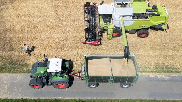 Mit einem Mähdrescher erntet ein Landwirt Getreide auf einem Feld bei Petershagen in Ostwestfalen (Luftaufnahme mit einer Drohne).
