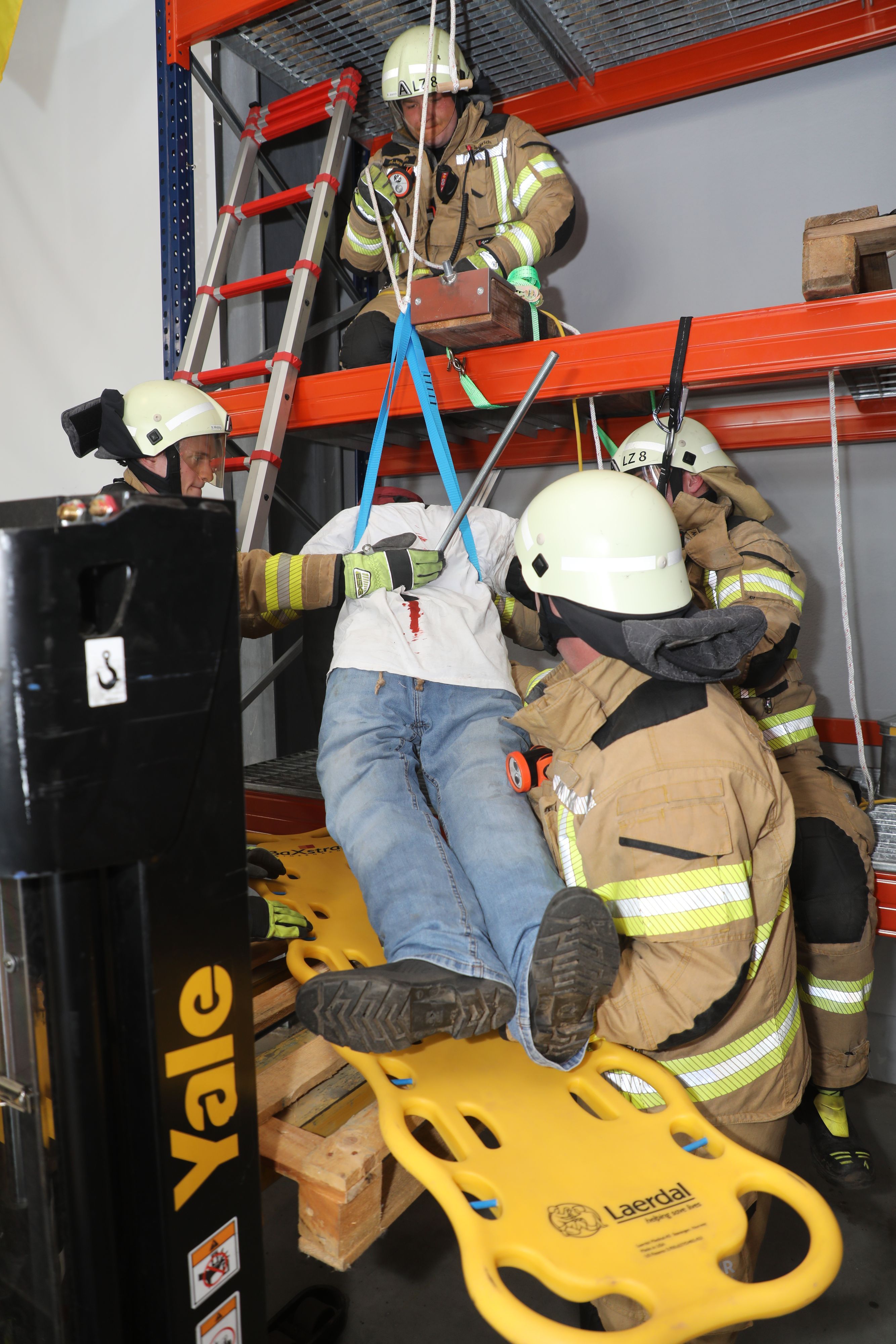 Ein Arbeiter ist nach einem Sturz von Gerüst auf eine Eisenstange gefallen, die seinen Korpus durchbohrt hat. Feuerwehrleute retten ihn.