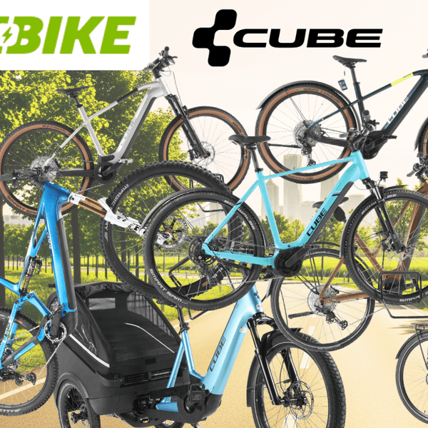 E-Bikes und Fahrräder der Marke Cube vor dem Hintergrund einer sonnigen Landstraße.