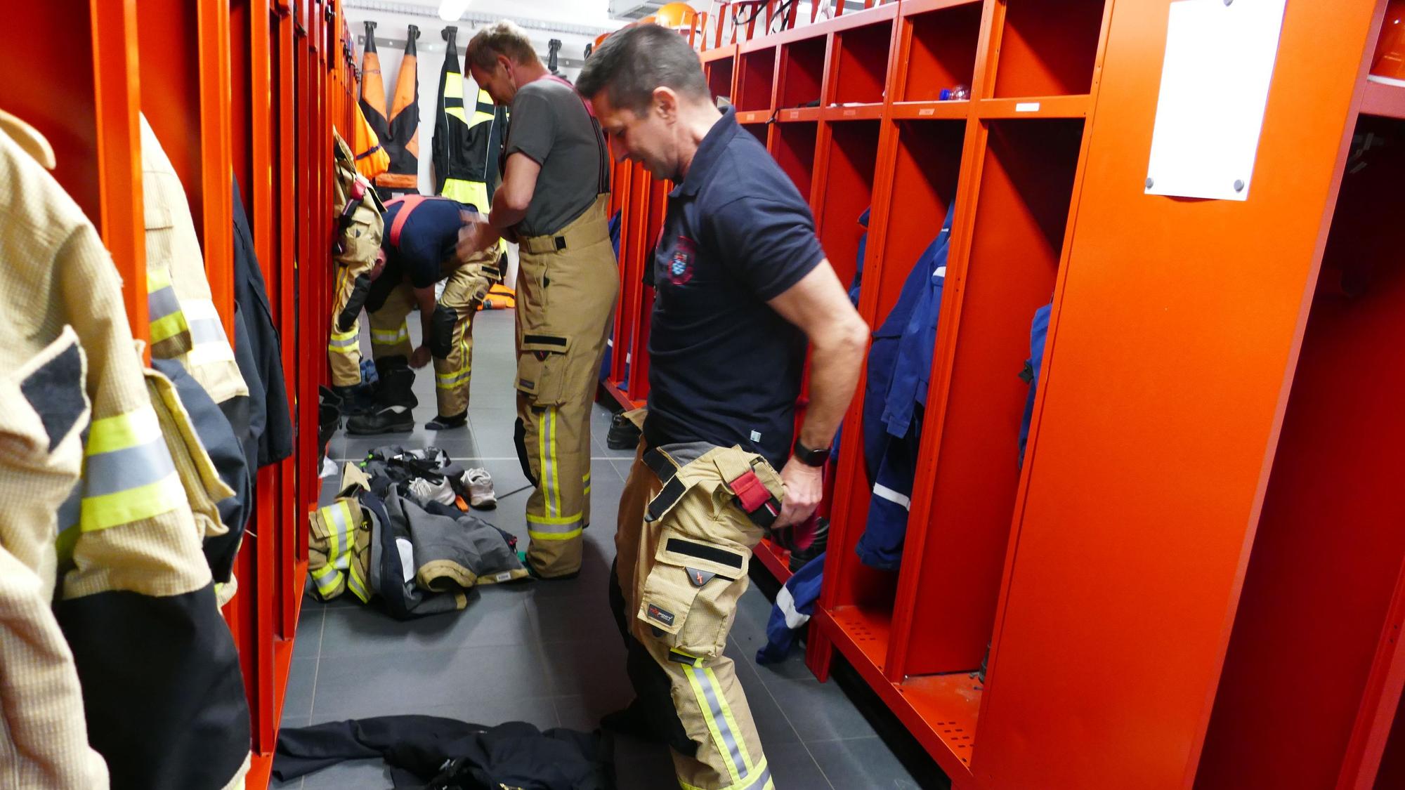 In Windeseile müssen Feuerwehrleute sich umgezogen haben. Die Latzhosen sind schnell übergestreift.