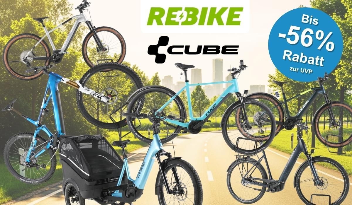 Cube E-Bike-Modelle vor einem Hintergrund einer Landstraße im Grünen vor einer Stadtsilhouette am sonnigen Tag.