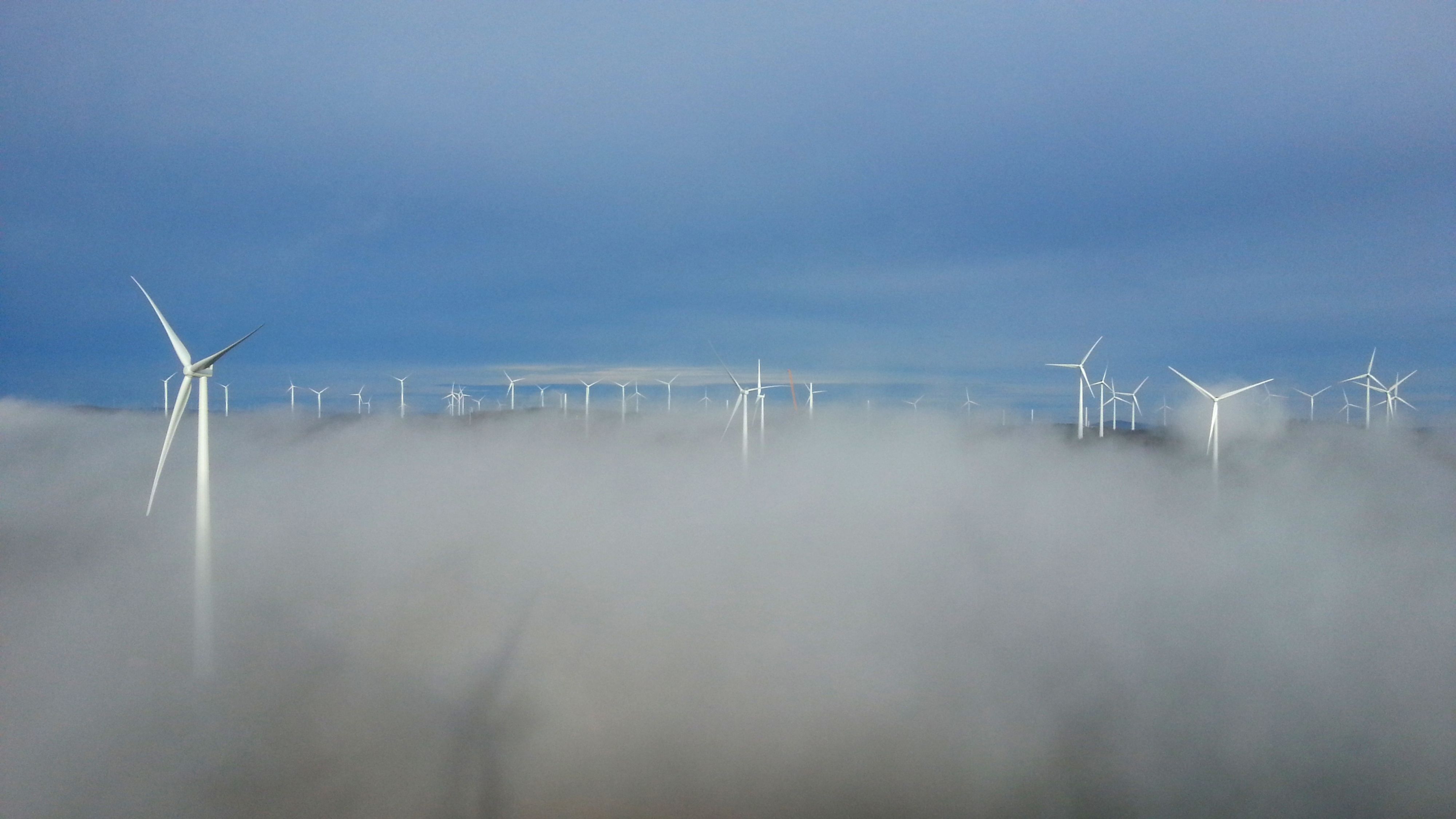 Wind Farm from height over the clouds in Swedish forest