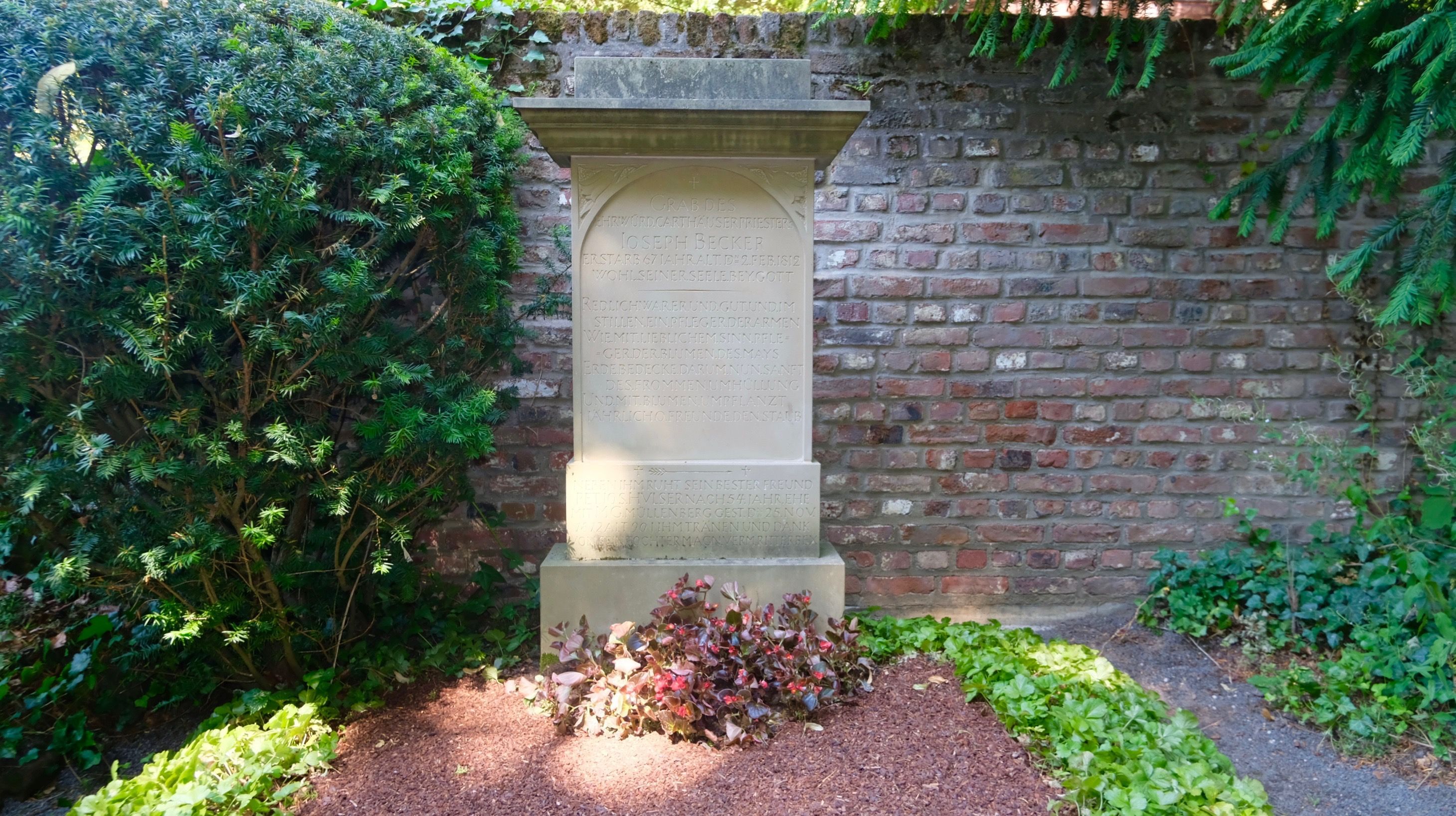 Ein Grab mit großer steinerner Säule ist zu sehen.