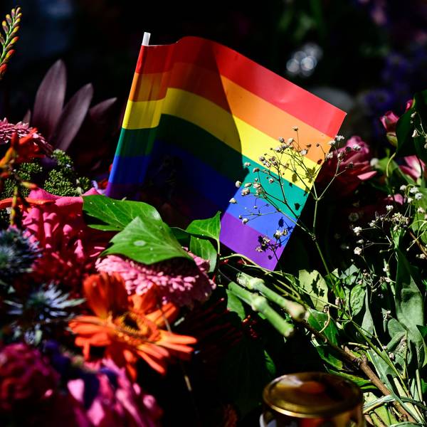 Flowers, a candle and a rainbow flag have been placed at a makeshift memorial in tribute to the victims at the Tiergarten park in Berlin on July 28, 2026, three days after a car ramming attack that killed one person and injured 29 near the Christopher Street Day (CSD) parade. German police had shot and killed the chief suspect in what officials described as a deadly Islamist attack near the Berlin Pride parade the night prior, the latest ramming assault to hit the country. The attack late on July 25 -- the first such incident to target the German capital's LGBTQ community, killed one woman and wounded 29 others. (Photo by John MACDOUGALL / AFP)