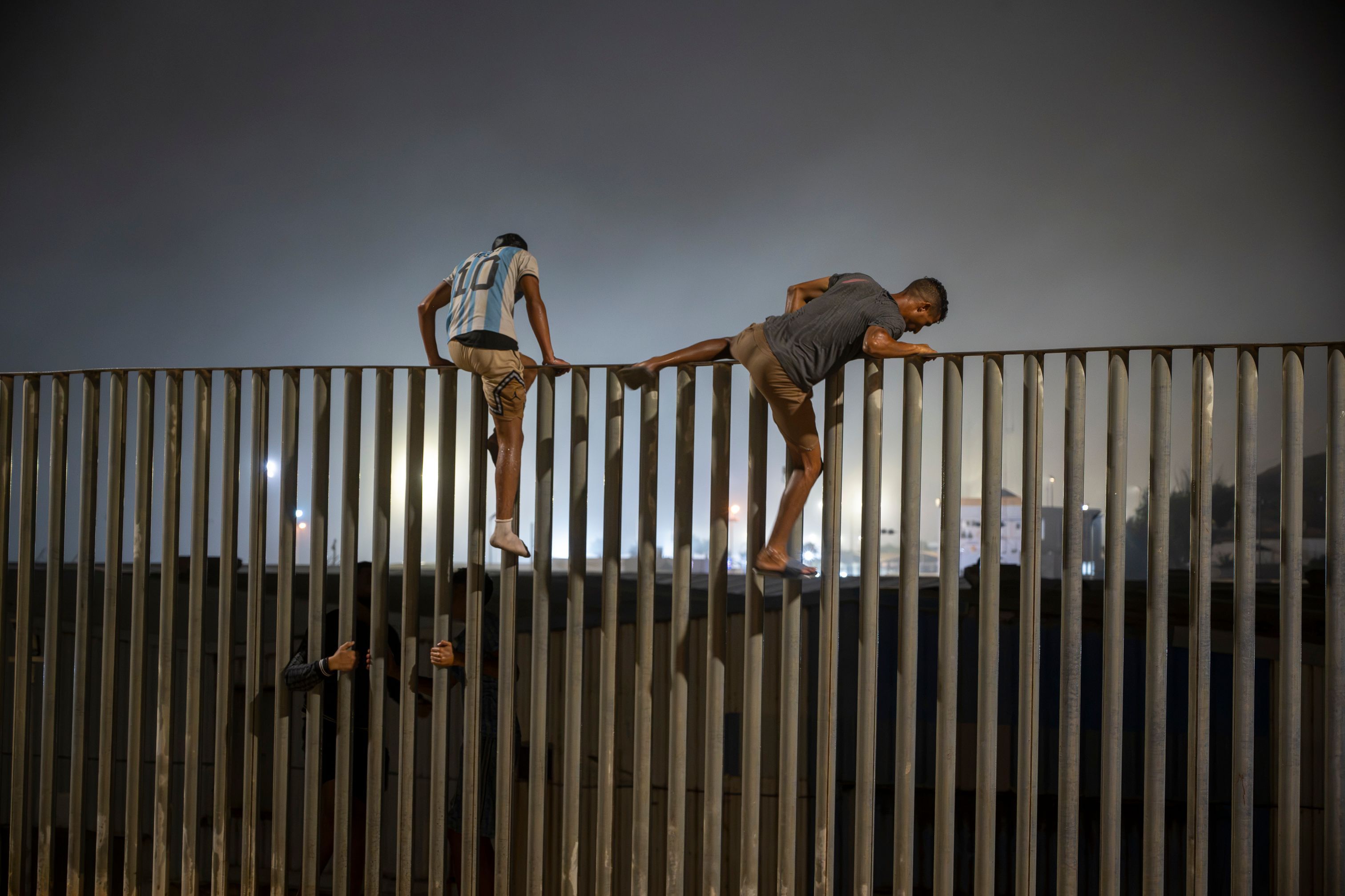 Migranten klettern über den Zaun, der die Grenze zwischen Ceuta und Marokko markiert.
