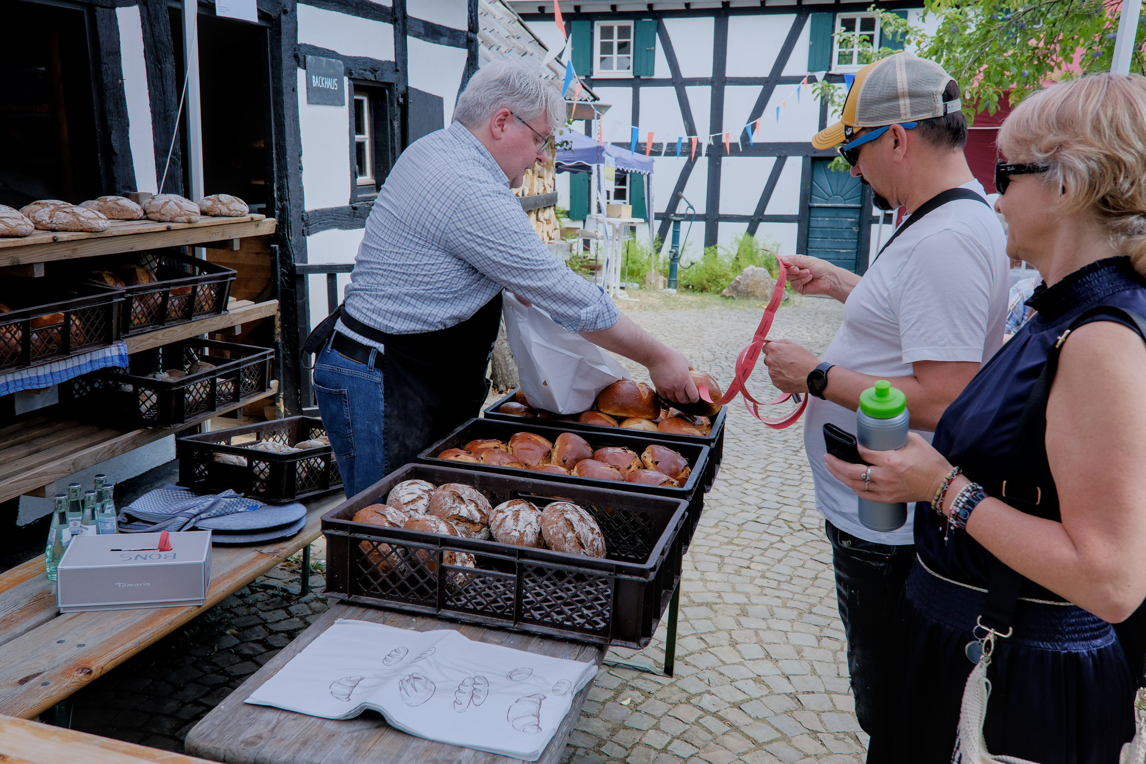 Ein Bäckermeister verkauft frisches Brot.