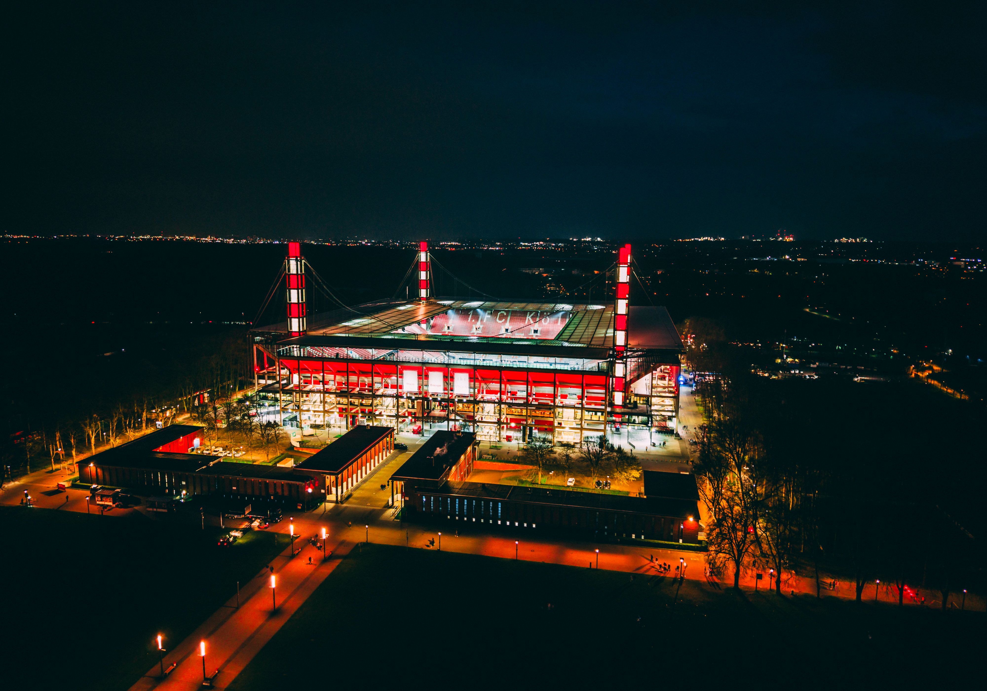 Luftaufnahme: beleuchtetes Rhein-Energie-Stadion von oben.