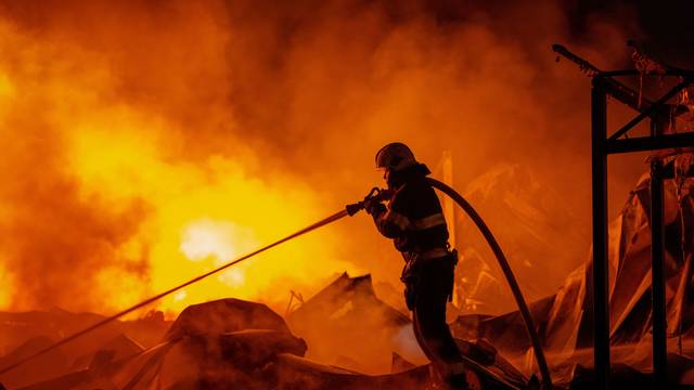 Feuerwehrleute löschten einen Brand, nachdem russische Raketen ein Lagerhaus getroffen hatten.