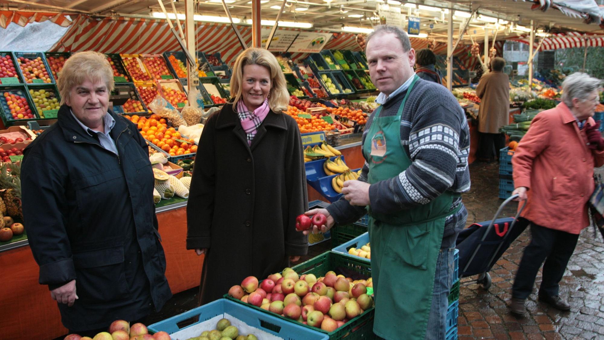 Ute Döpper (heute: Unrau) steht mit Marktbeschickern und Ordnungsamtsmitarbeiterin auf dem Gladbacher Wochenmarkt.