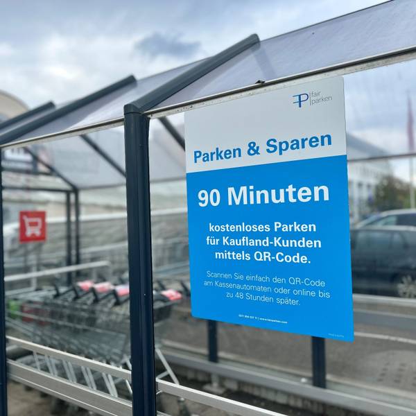 An einer Scheibe hängt ein blaues Schild.