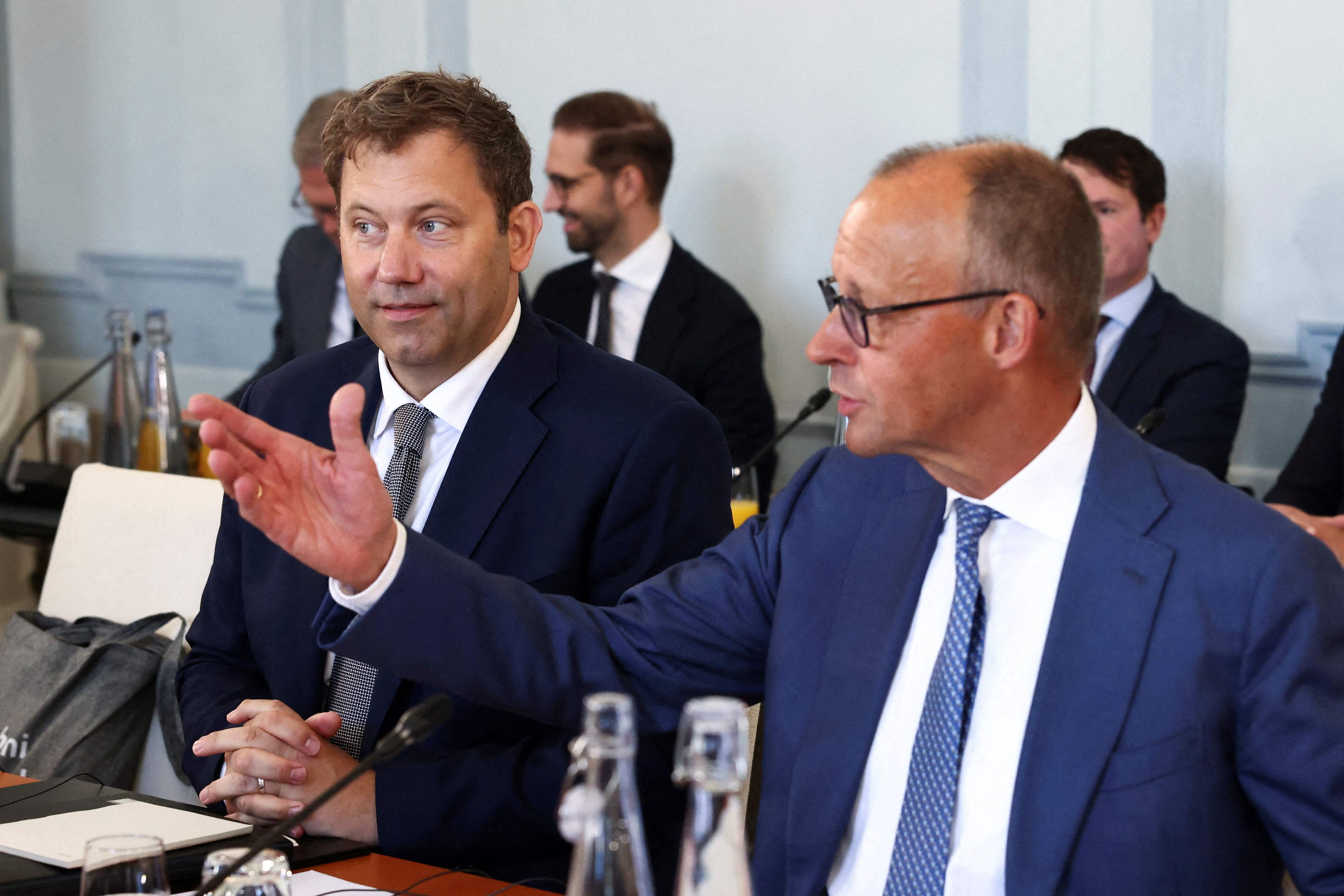 German Chancellor Friedrich Merz (R) and German Finance Minister and Vice Chancellor Lars Klingbeil attend a two day  retreat meeting of the German cabinet on August 25, 2026 in Neuhardenberg, northeastern Germany. (Photo by Liesa Johannssen / POOL / AFP)
