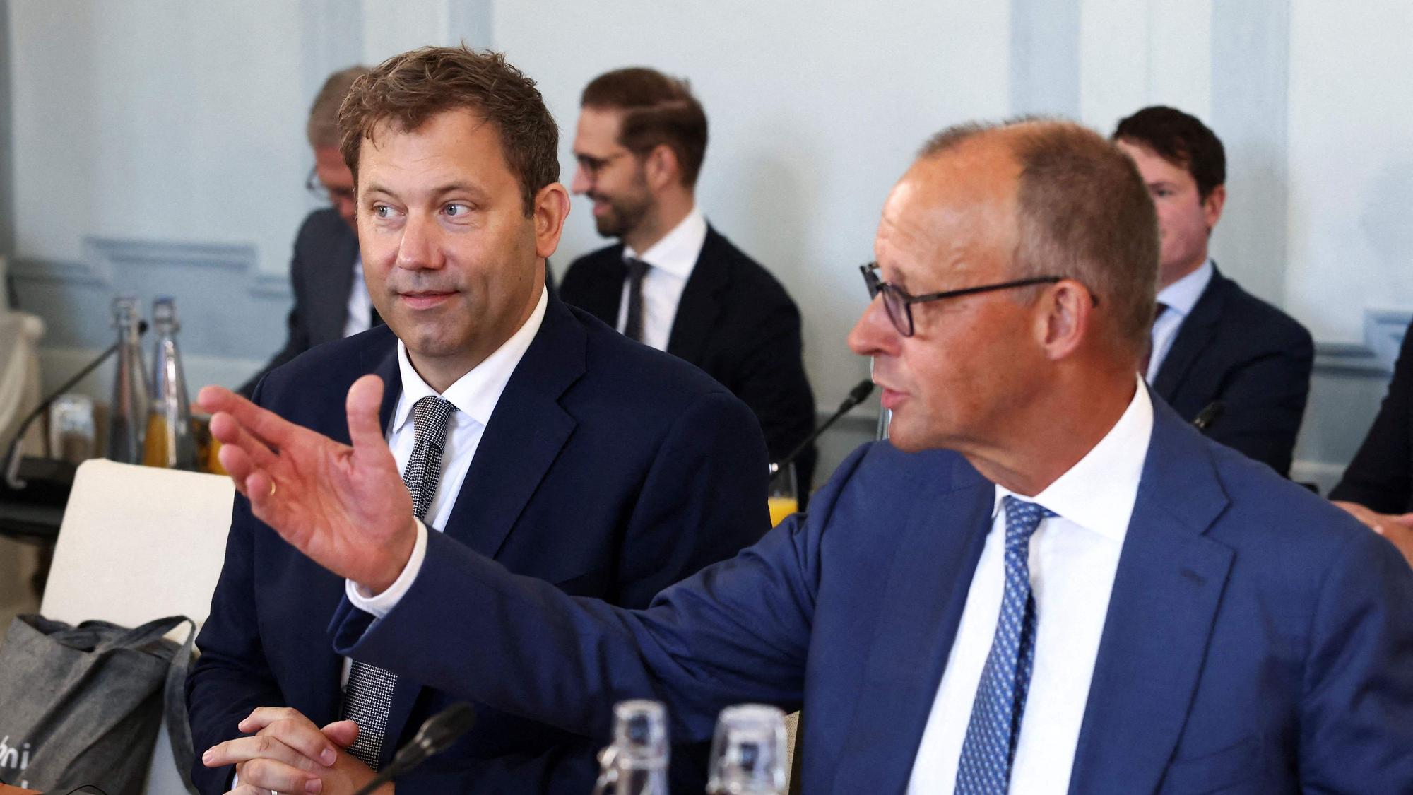 German Chancellor Friedrich Merz (R) and German Finance Minister and Vice Chancellor Lars Klingbeil attend a two day retreat meeting of the German cabinet on August 25, 2026 in Neuhardenberg, northeastern Germany. (Photo by Liesa Johannssen / POOL / AFP)