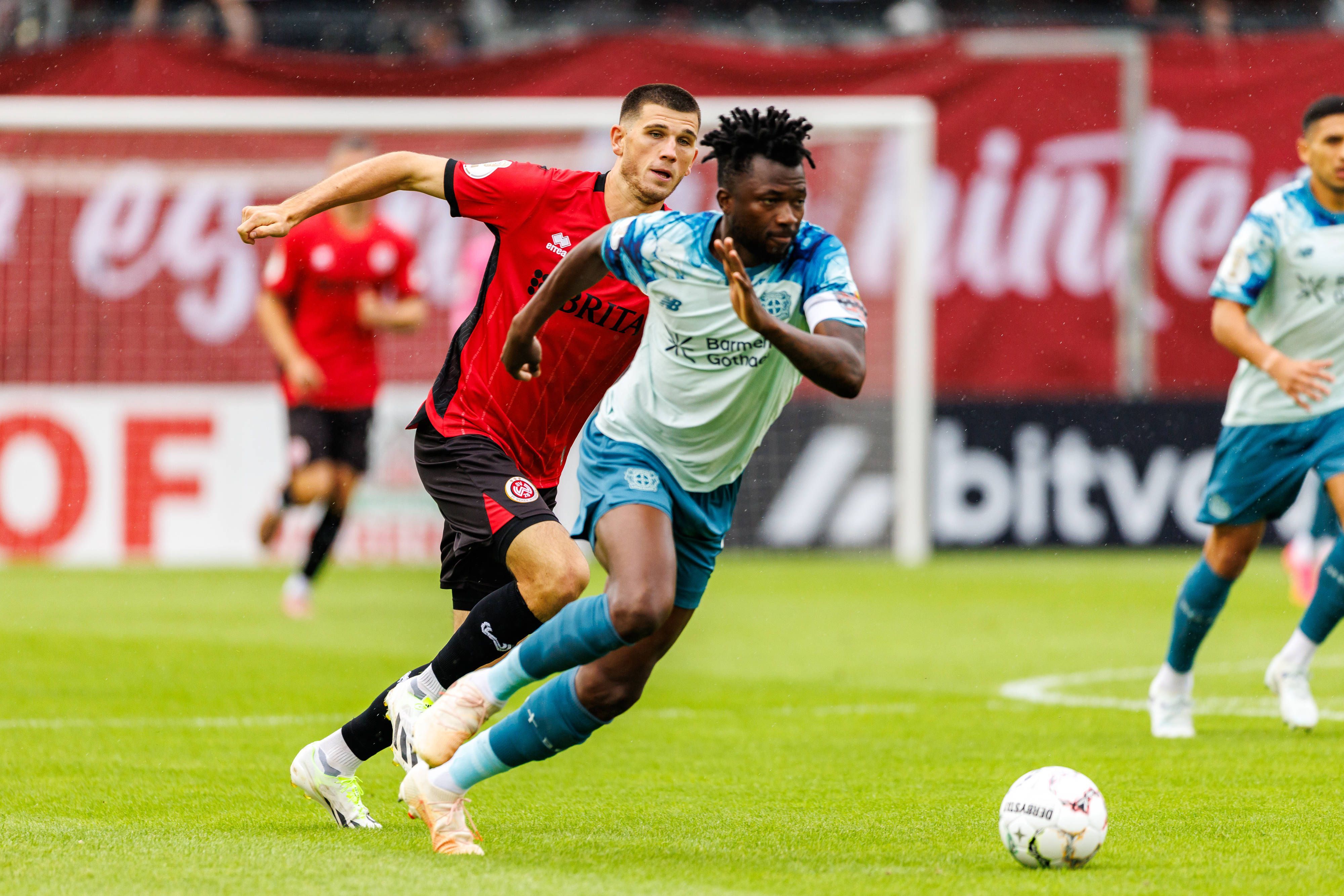WIESBADEN, GERMANY - AUGUST 22: Edmond Tapsoba Bayer 04 Leverkusen, 12 is challenged by Moritz Flotho SV Wehen Wiesbaden, 28 during the first-round match between SV Wehen Wiesbaden vs. Bayer 04 Leverkusen at Brita Arena of the German Cup on August 22, 2026 in Wiesbaden, Germany. DFL REGULATIONS PROHIBIT ANY USE OF PHOTOGRAPHS AS IMAGE SEQUENCES AND/OR QUASI-VIDEO. Hessen Germany Copyright: xStephanxHahnex