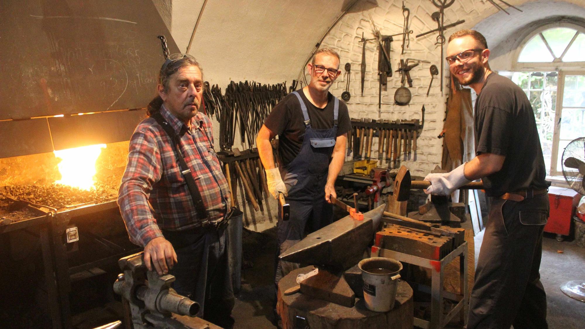 Henning (links) und Timo Schulzke (rechts) stehen in der Schmiede-Werkstatt von Andreas Müller.