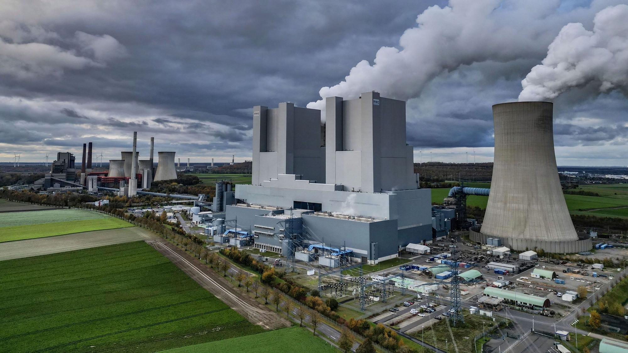 Wasserdampf steigt aus den Kühltürmen des RWE-Braunkohlekraftwerks Neurath.