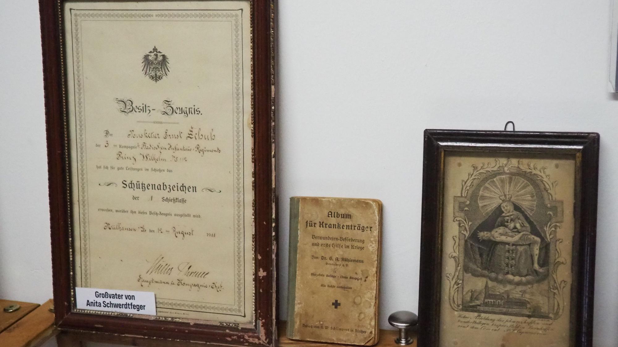Das Foto zeigt Urkunden, Bilder und ein „Album für Krankenträger“.