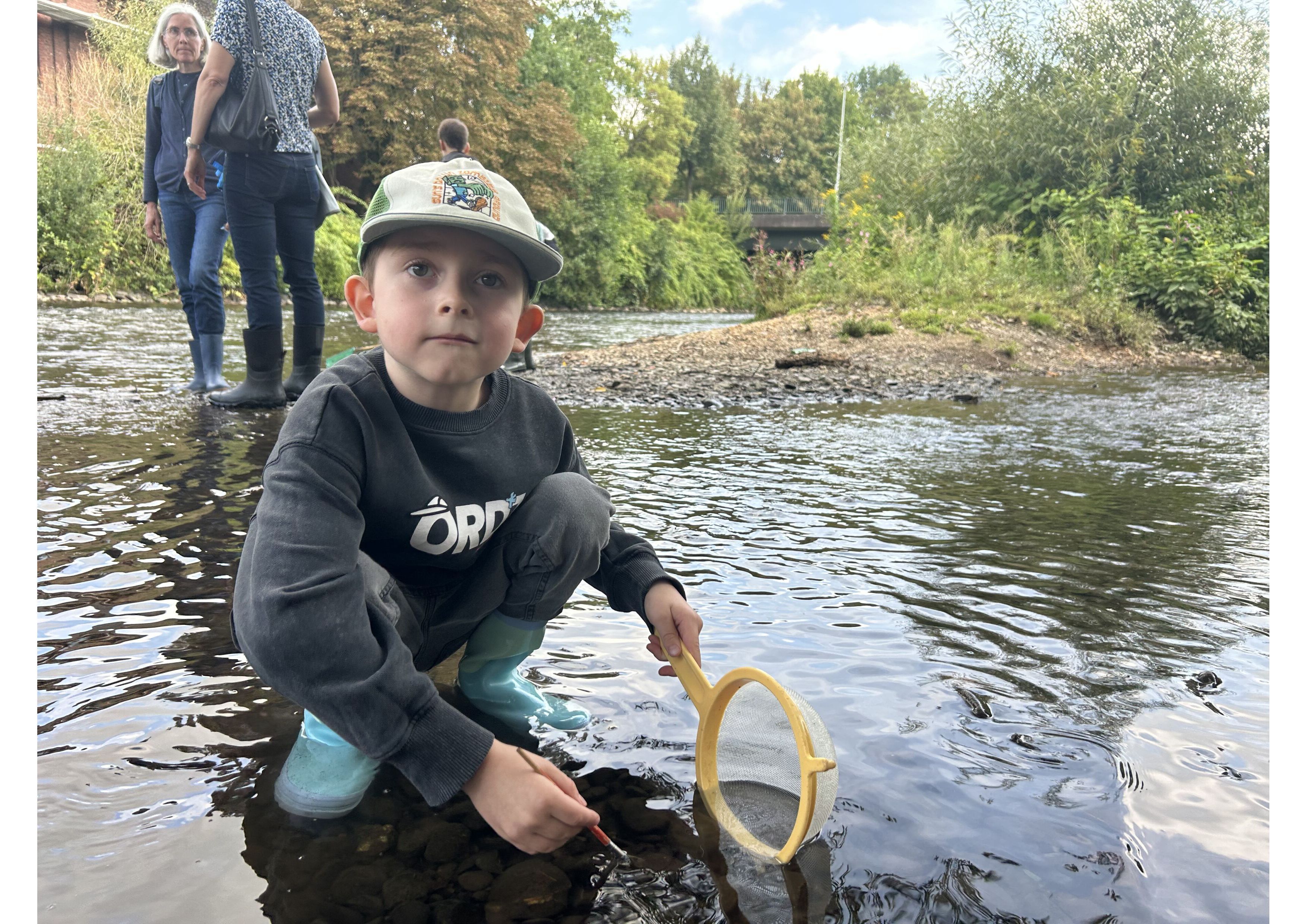 Mit Kescher und Gummistiefeln sucht Moritz (6) in der Wupper nach kleinen Wasserbewohnern.