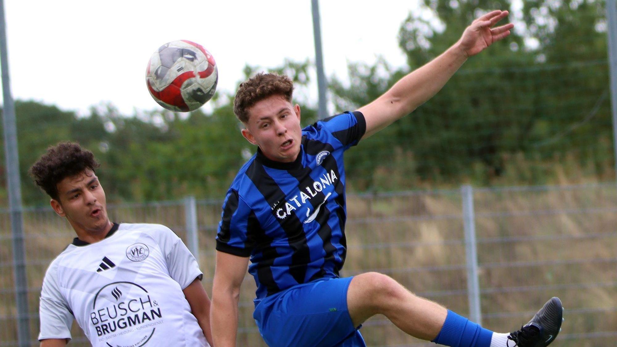 Der Bessenicher Fußballspieler Moritz Hoch trägt ein blau-schwarzes Trikot und springt zum Kopfball hoch.