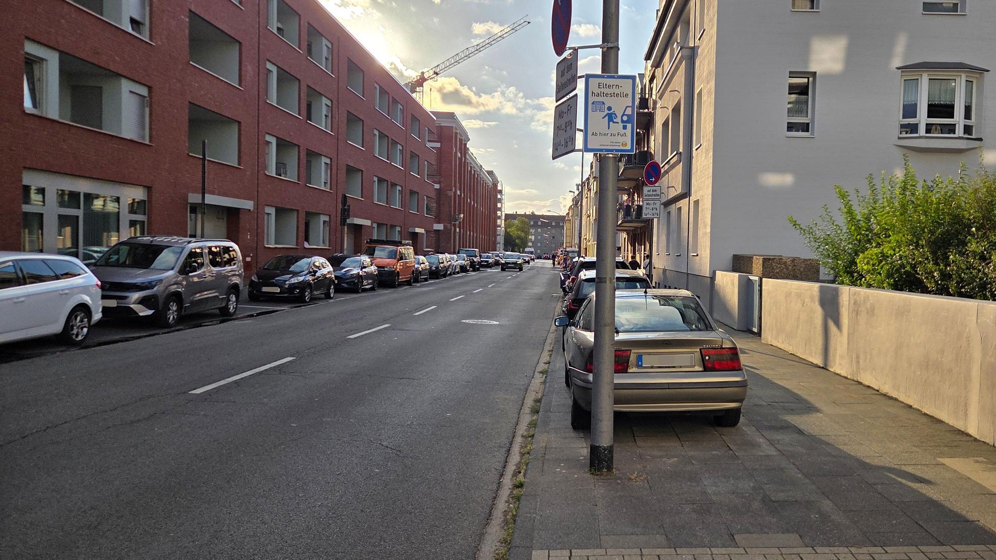 Die Stadt Köln hat wie hier an der Xantener Straße in Nippes an drei Schulen Elternhaltestellen eingerichtet und dafür Hinweisschilder aufgestellt.
