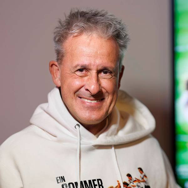 Pierre Littbarski lächelt in die Kamera.