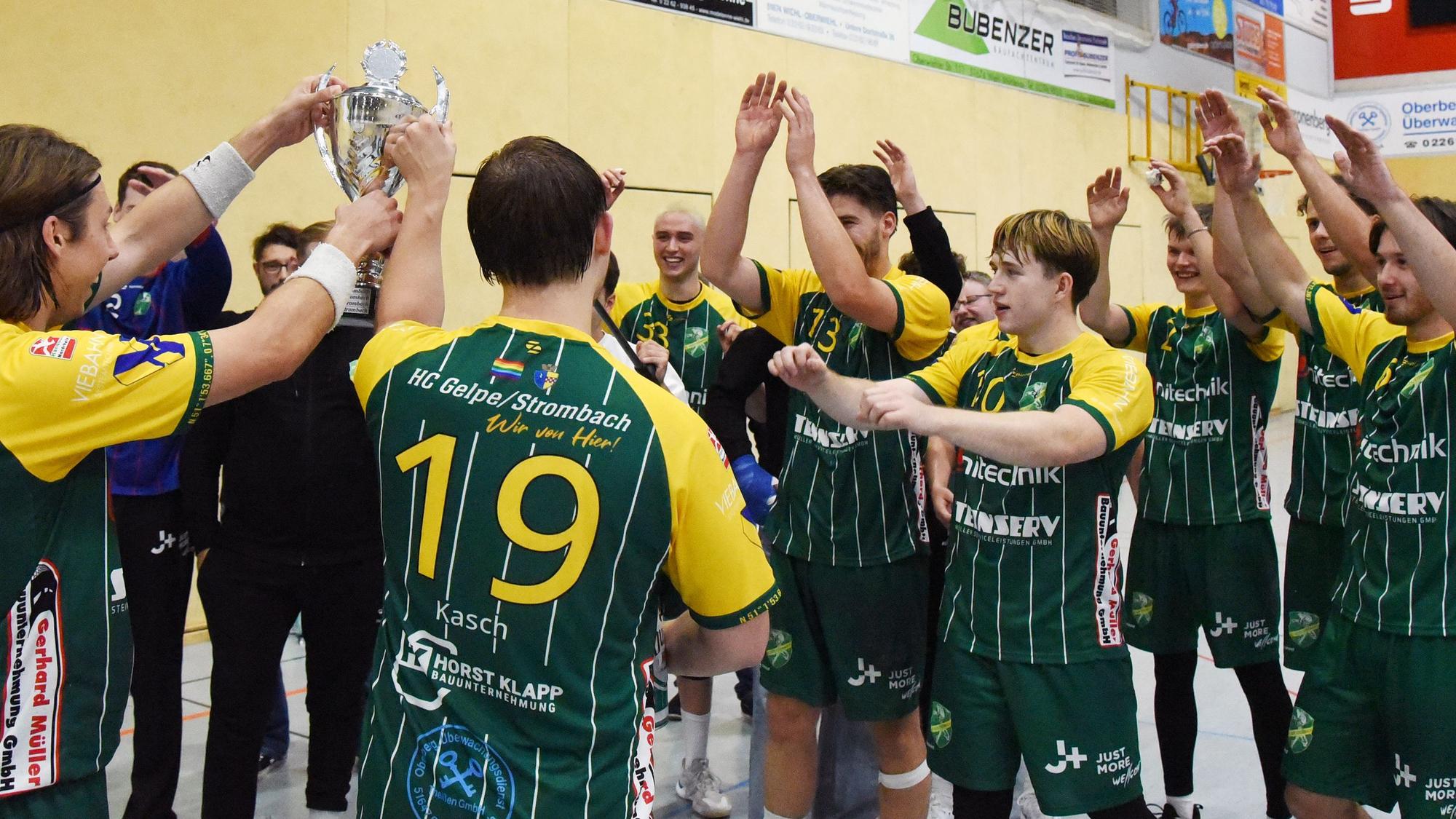 Die Handballer des HC Gelpe/Strombach jubeln mit dem Pokal.