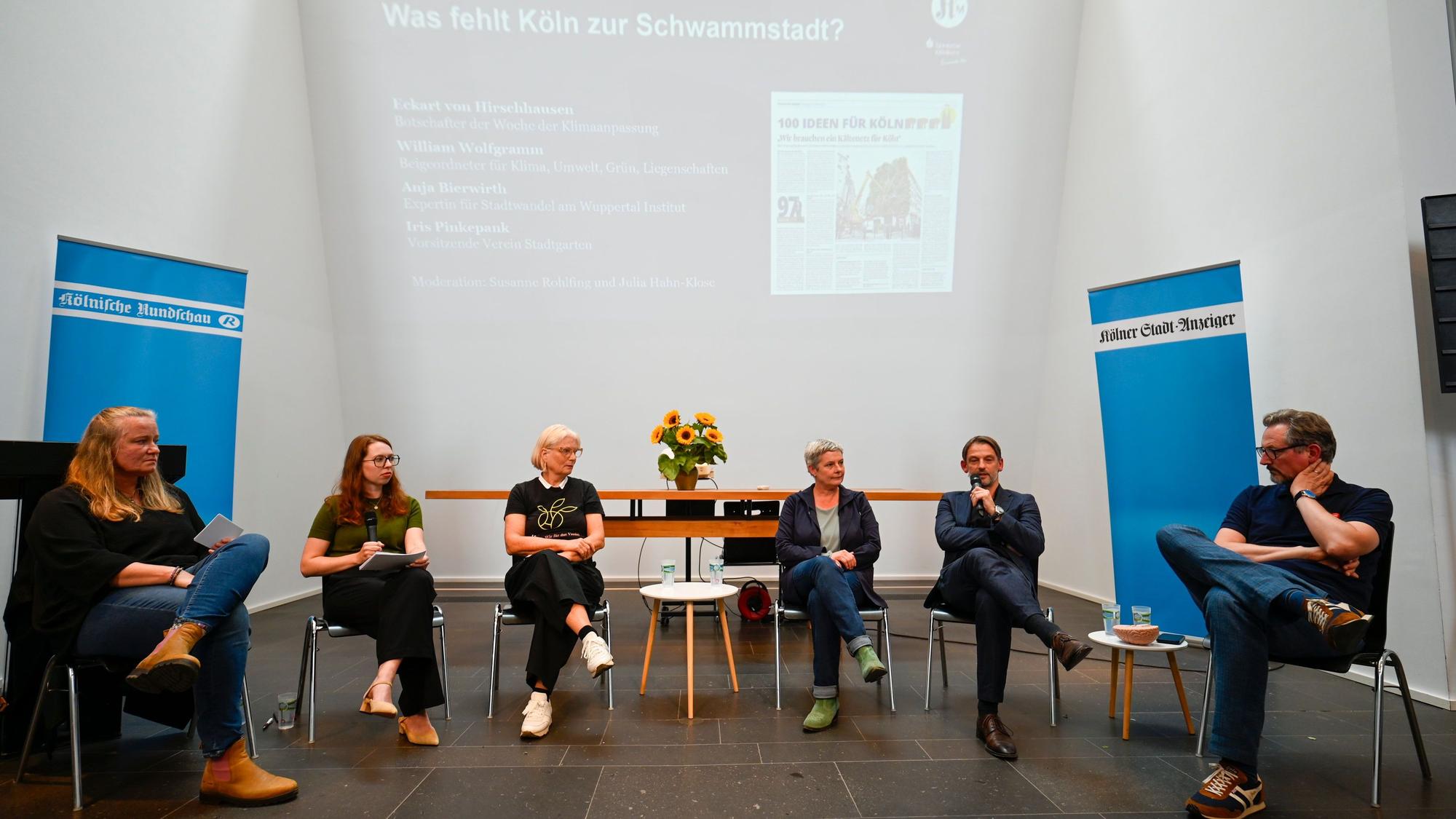 Auf dem Podium v.r.: Eckart von Hirschhausen (Arzt, Moderator und Wissenschaftsjournalist), William Wolfgramm (Kölns Umweltdezernent), Anja Bierwirth (Leiterin des Forschungsbereichs Stadtwandel am Wuppertal Institut) und Iris Pinkepank (Vorsitzende des Stadtgarten-Vereins) sowie die beiden Moderatorinnen.