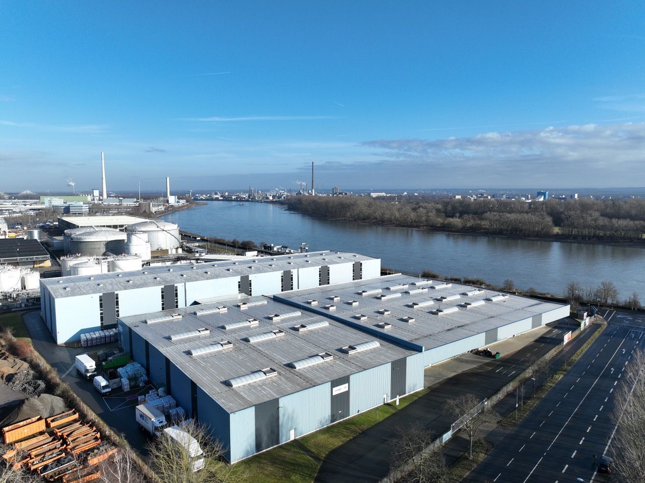 Blick auf die Logistikhallen am Niehler Rheinufer: Die höhere der beiden Hallen, im Hintergrund, beziehen die KVB als Lagerstätte.