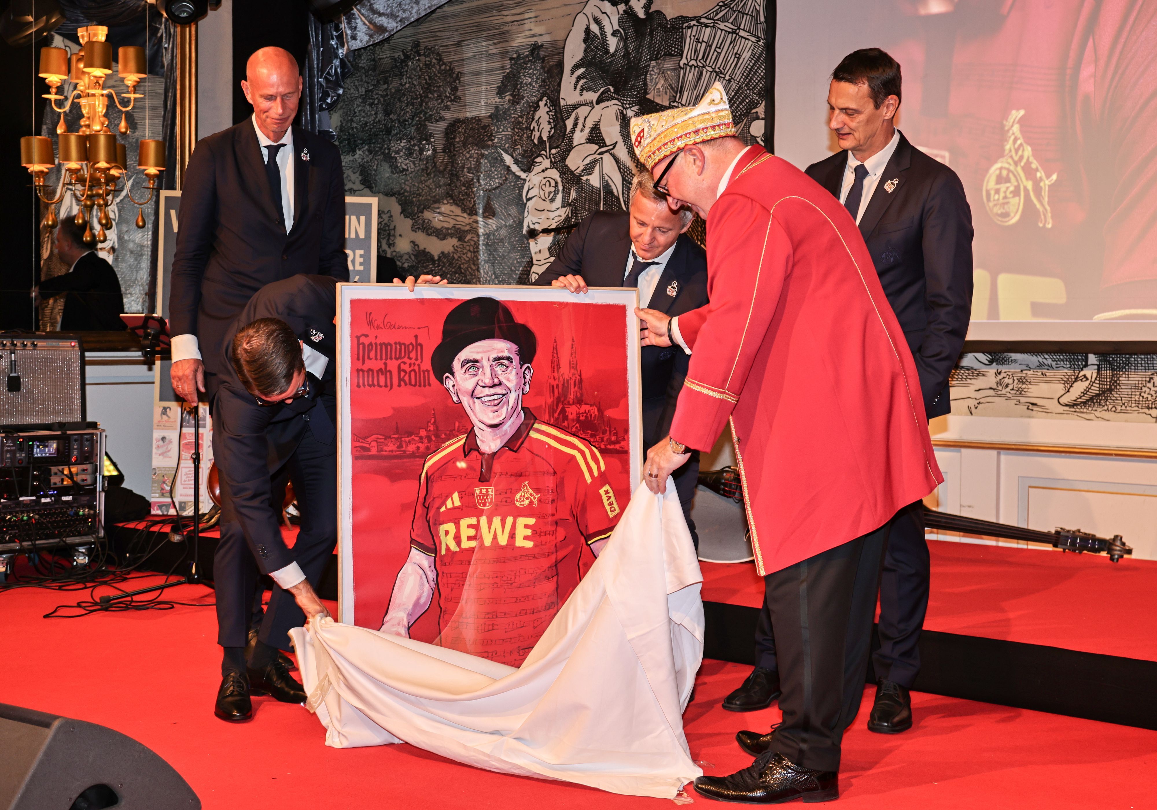 Der FC-Vorstand überreicht ein Bild von Willi Ostermann im Kölner Trikot.