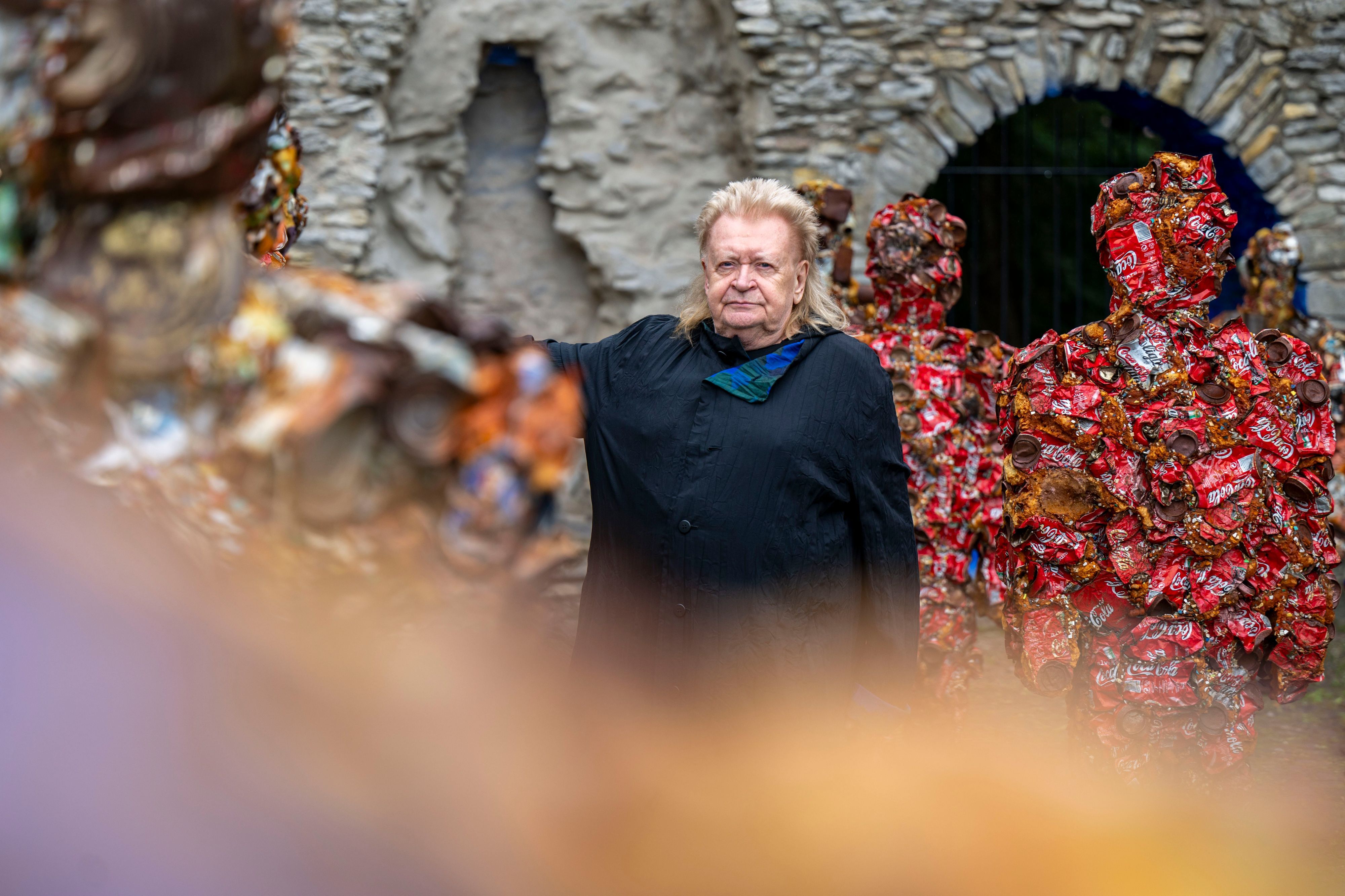 Der Künstler Hans-Jürgen Schult steht an seiner Installation Trash People aus Müll.