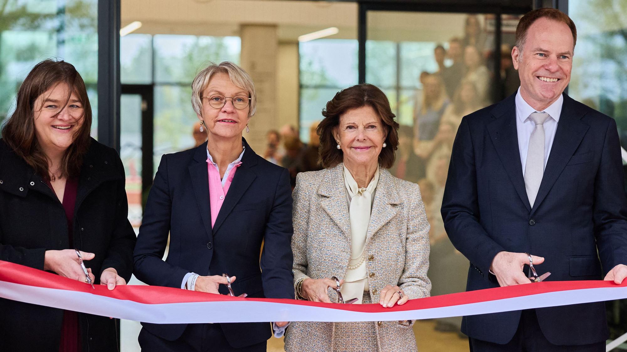 Königin Silvia von Schweden schneidet bei der Eröffnung des Luisen-Gymnasiums ein Band durch mit Gabriele Patten (l), Schulleiterin, Dorothee Feller (2.v.l., CDU), Ministerin für Schule und Bildung des Landes Nordrhein-Westfalen, und Stephan Keller, Oberbürgermeister von Düsseldorf.