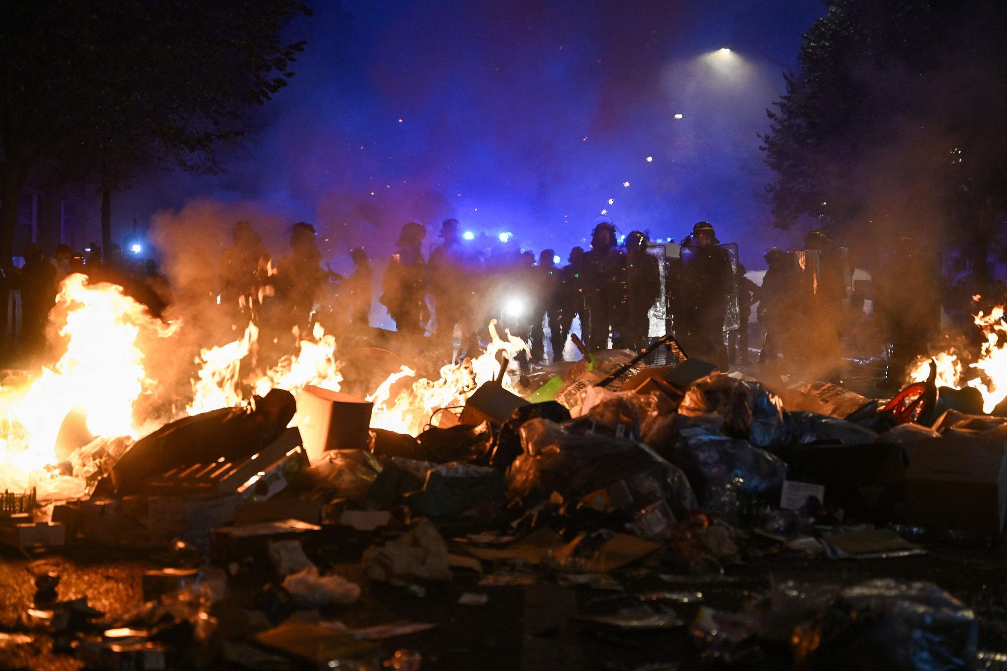 Polizisten stehen am 18. Oktober hinter einem Feuer in der Nähe der Place de la République im Zentrum von Paris.