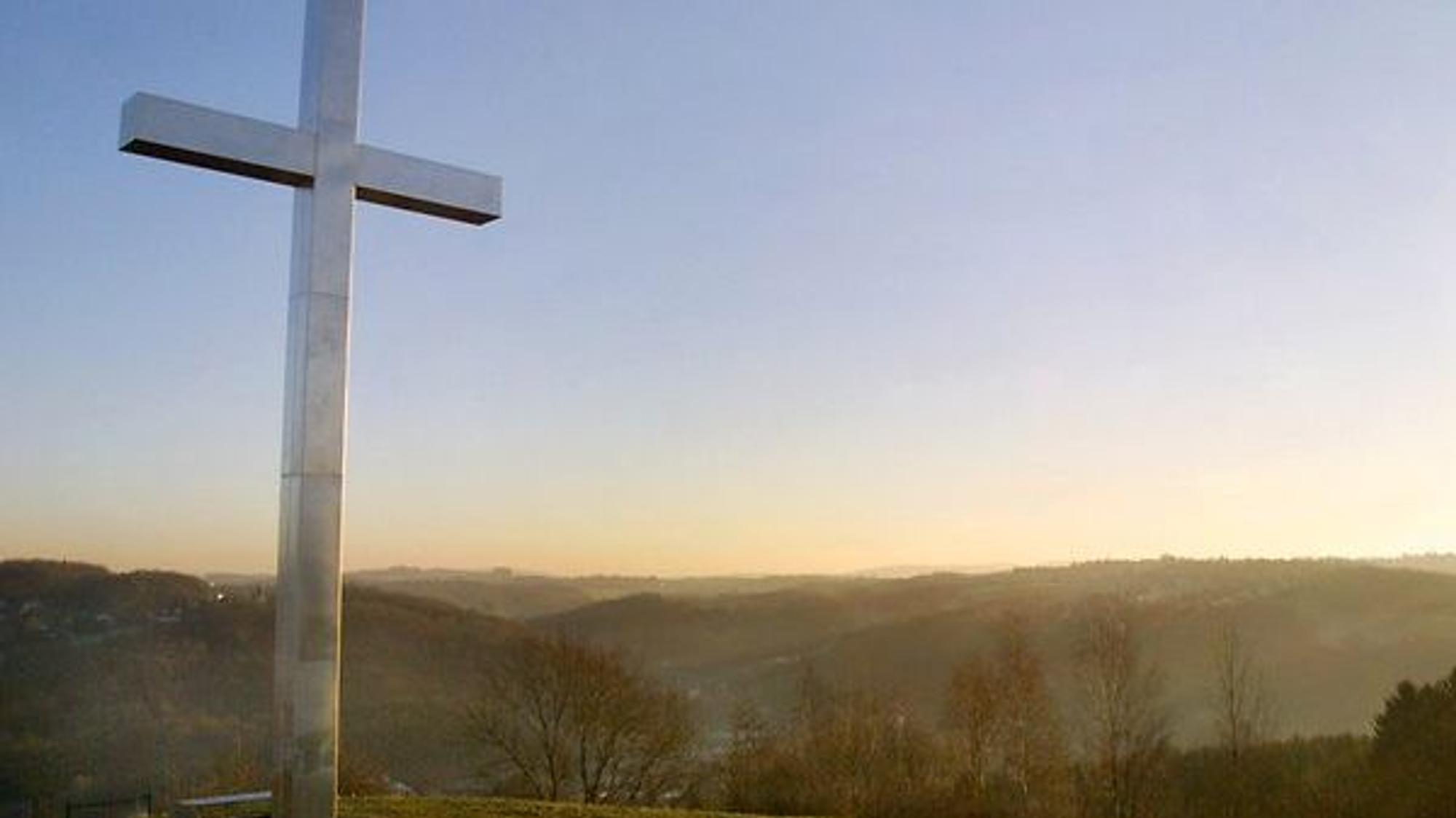 Gipfelkreuz aus Stein im Nebel