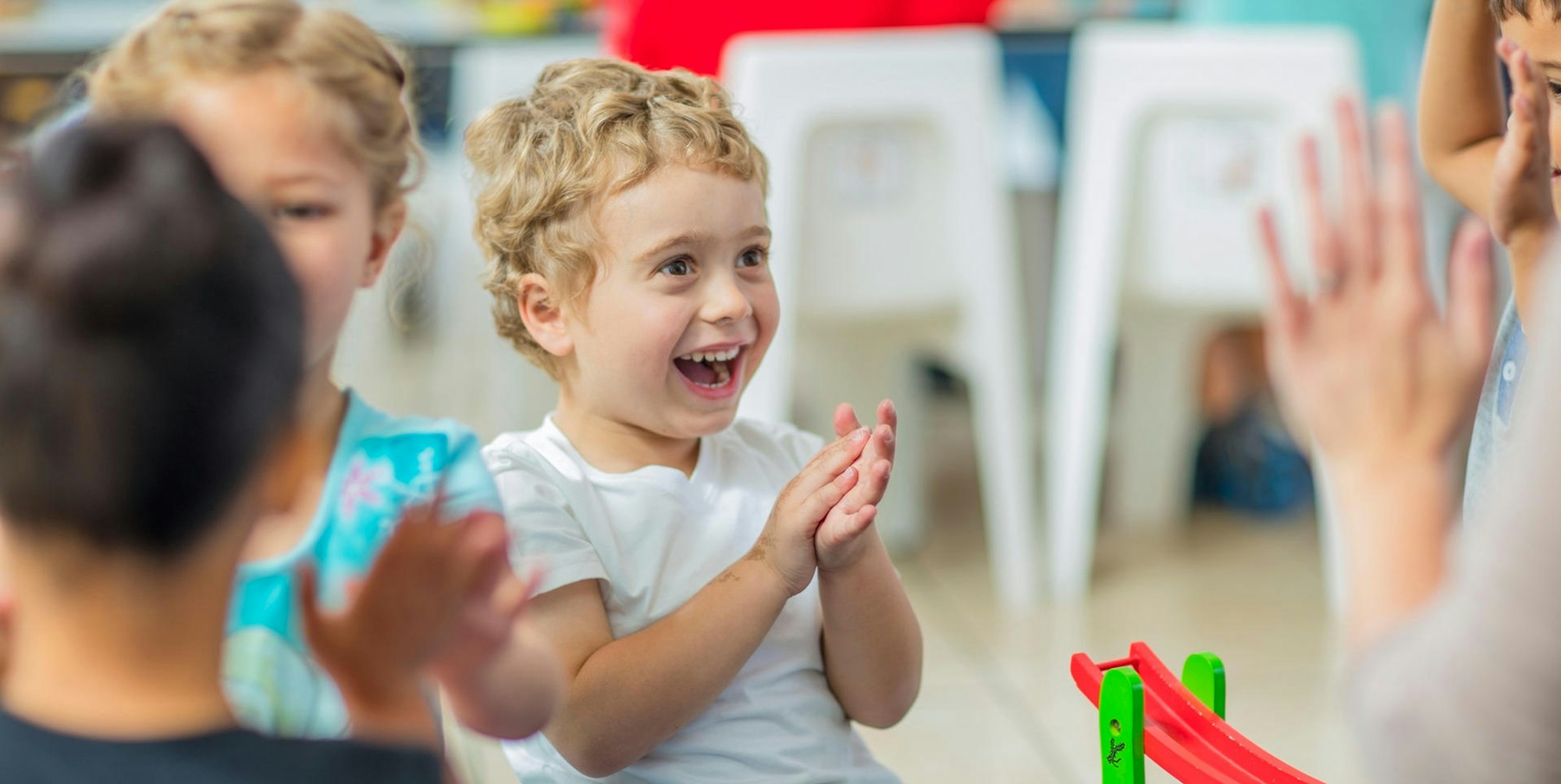 Kinder klatschen in einer Kita.