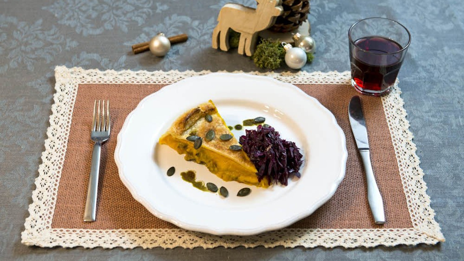 Ein Stück Kürbispastete mit Rotkohl liegt auf einem Teller.