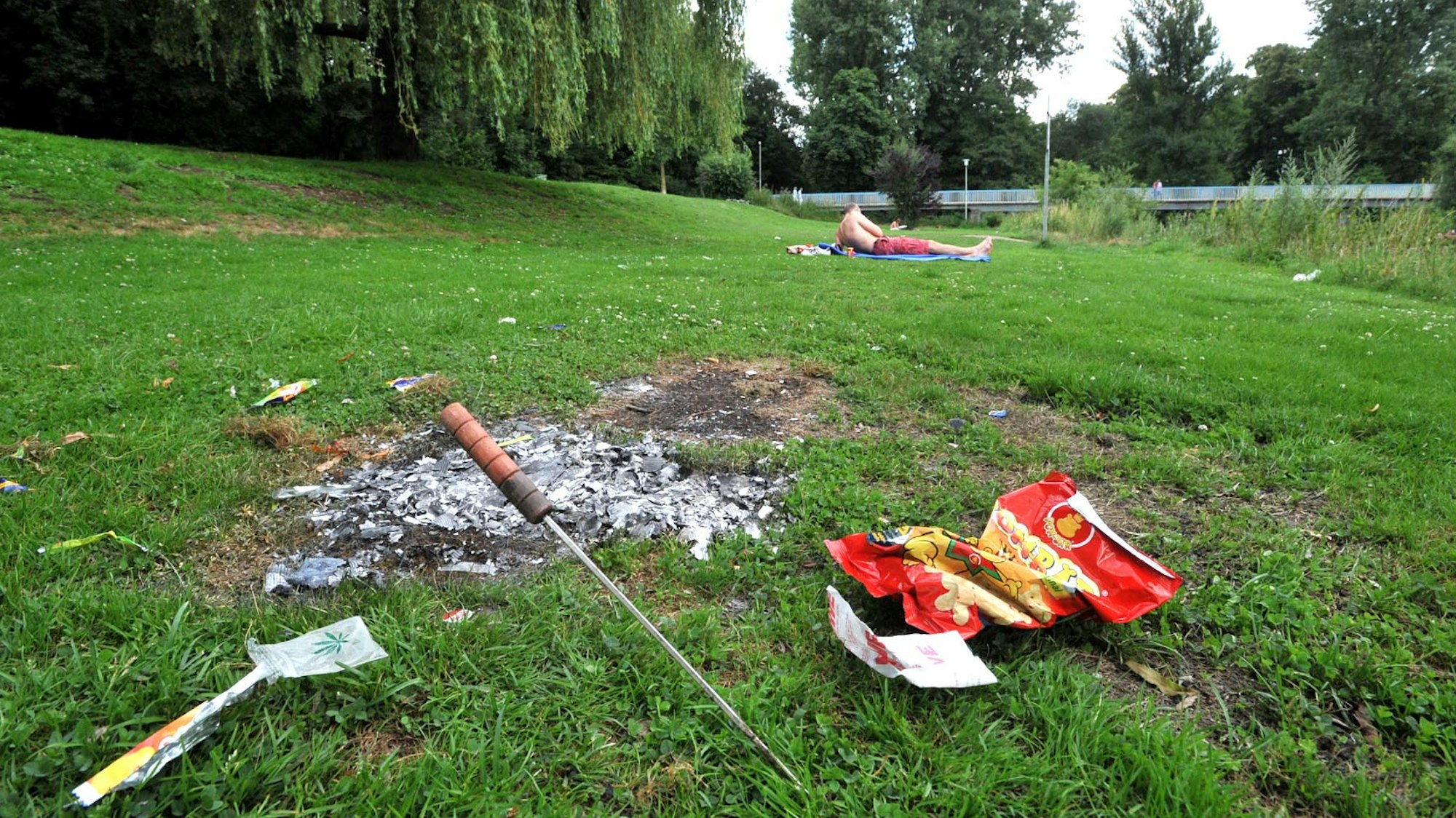 Verbrannter Rasen und Müll auf der Wupperwiese