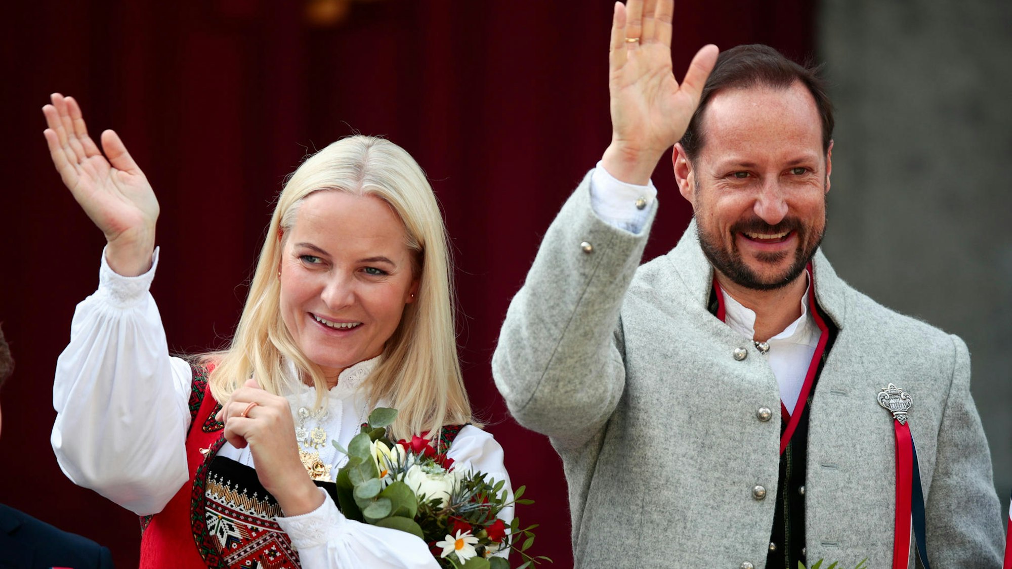 Kronprinzessin Mette-Marit und Kronprinz Haakon winken.