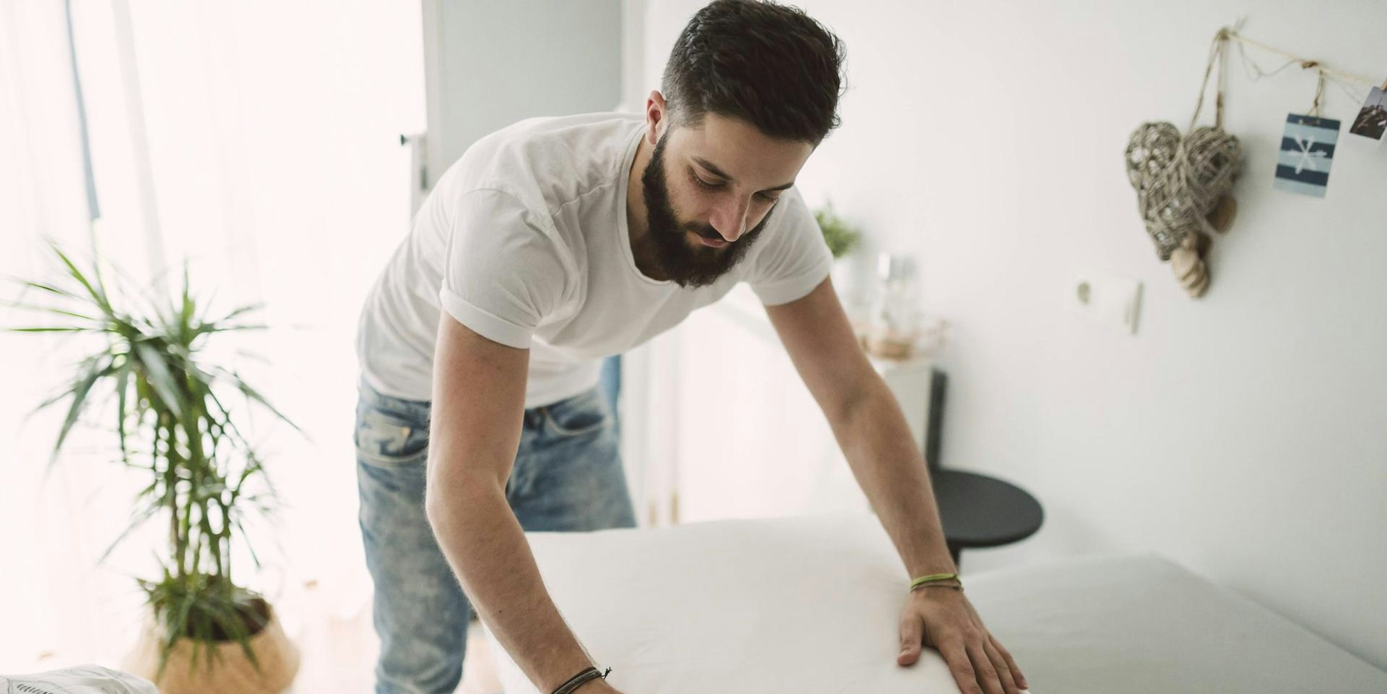 Mann macht sein Bett imago