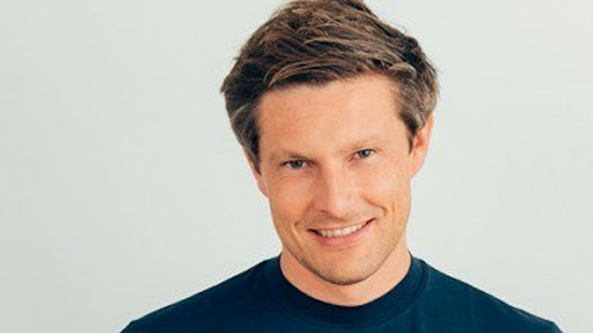 Sven-Oliver Pink, einer der Ergobag-Gründer, lächelt in die Kamera.